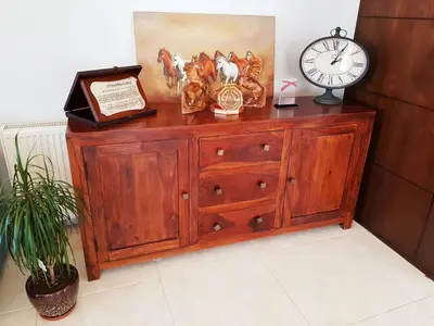 a wooden dresser with a clock on top of it at Luxury 3 bedrooms flat with great view of Amman in Amman