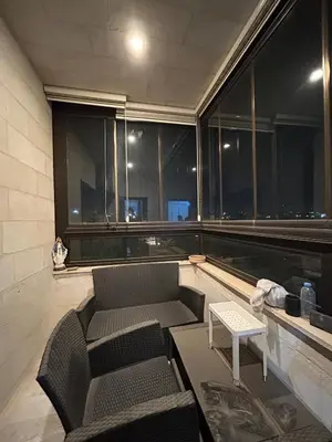 a living room with a couch and some windows at 3BR Escape with Outdoor Scenic Views in Amman