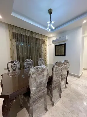 a dining room with a wooden table and chairs at 3BR Escape with Outdoor Scenic Views in Amman