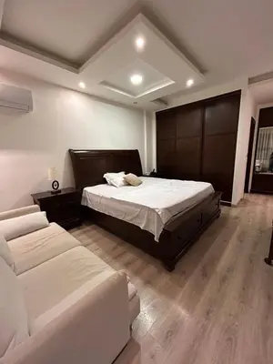 a bedroom with a large bed and a couch at 3BR Escape with Outdoor Scenic Views in Amman