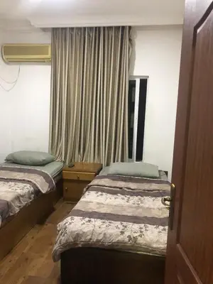 a hotel room with two beds and a window at رياحين الخلود in Amman