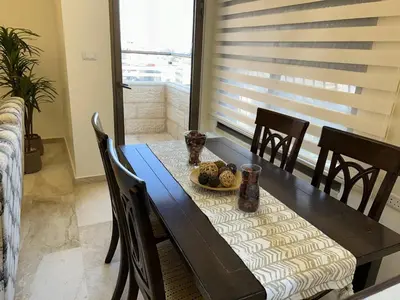 a dining room table with a plate of food on it at 3 bedroom flat, 3 bathrooms, 7th circle, Amman in Amman