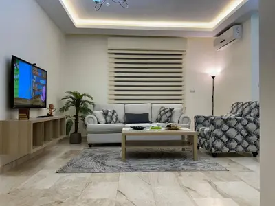 a living room with a couch and a tv at 3 bedroom flat, 3 bathrooms, 7th circle, Amman in Amman
