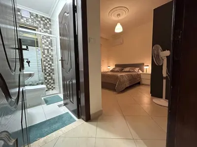 a bedroom with a bed and a bathroom with a shower at 3 bedroom flat, 3 bathrooms, 7th circle, Amman in Amman