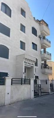 a large building with a gate in front of it at 2bedrooms sport city in Amman