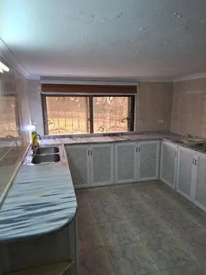 an empty kitchen with a sink and a window at Mountain Pad Overlooking Jerash - HQ Budget stay in Jerash