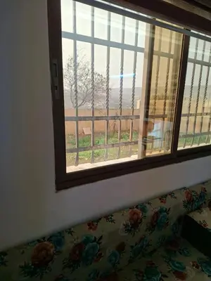 a couch sitting in front of a window with a view at Mountain Pad Overlooking Jerash - HQ Budget stay in Jerash