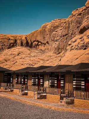 a building in the desert with a mountain in the background at Victoria rum Luxury camp in Disah