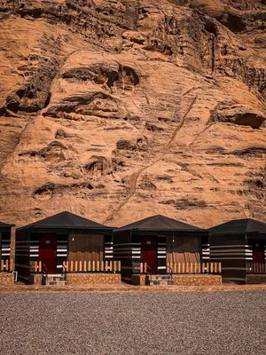 a building in front of a rocky mountain at Victoria rum Luxury camp in Disah