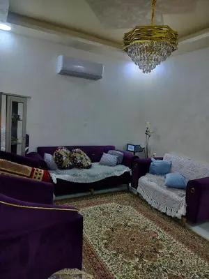 a living room with a purple couch and a chandelier at شقق مفروشه فاخره2 in Aqaba