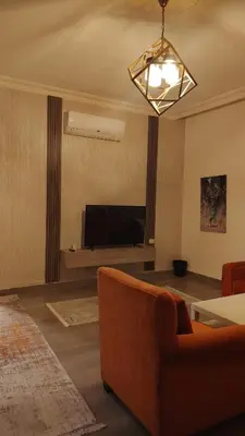 a living room with a couch and a flat screen tv at home 7 in Amman