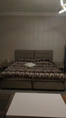 a bedroom with a bed with a brown comforter at home 7 in Amman