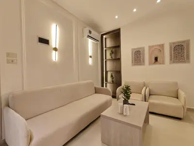 a living room with a couch and a table at ذا سهل ستيز in Amman