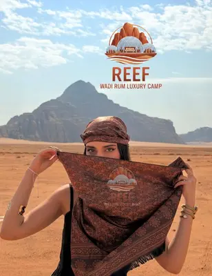 a woman holding a scarf in the desert at Reef Rum Luxury Camp in Disah
