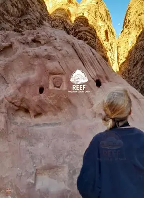 a woman standing in front of a rock formation at Reef Rum Luxury Camp in Disah