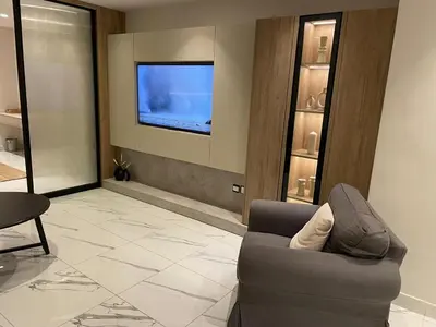 a living room with a couch and a tv at Damac Towers TC1-517 in Amman