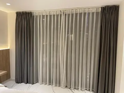 a bedroom with a window with gray curtains at Damac Towers TC1-517 in Amman