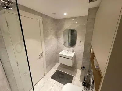 a bathroom with a toilet and a sink and a shower at Damac Towers TC1-517 in Amman