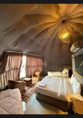 a bedroom with a large bed in a tent at Wadi rum Nader in Aqaba