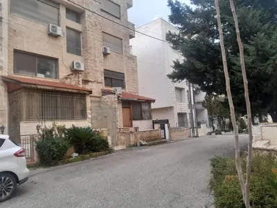 an empty street in front of a building at استديو للتأجير السنوي او البيع in Amman