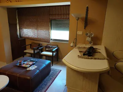 a small living room with a table and a stool at استديو للتأجير السنوي او البيع in Amman