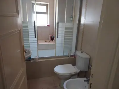 a bathroom with a toilet and a sink and a mirror at استديو للتأجير السنوي او البيع in Amman