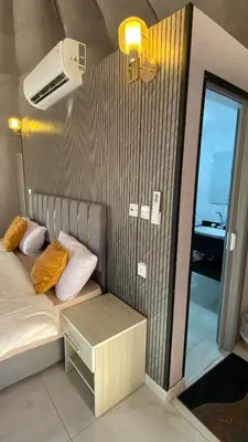 a room with a bed with a table and a fan at Fortuna Rum Bubble Hotel & Jeep Tours in Wadi Rum