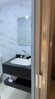 a bathroom with a white sink and a mirror at Fortuna Rum Bubble Hotel & Jeep Tours in Wadi Rum