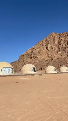 a group of three domes in front of a mountain at Fortuna Rum Bubble Hotel & Jeep Tours in Wadi Rum
