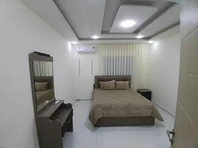 a bedroom with a bed and a mirror in it at شقق السعادة 2 in Amman