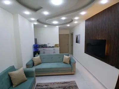 a living room with a couch and a flat screen tv at شقق السعادة 2 in Amman