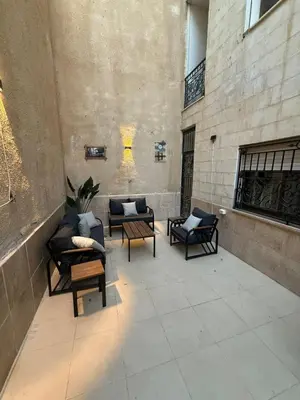 a patio with chairs and tables in a building at شقة مميزة في عبدون -Special apartment in Abdon in Amman