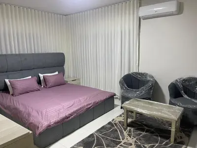 a bedroom with a bed and a table and chairs at jordanien madaba in Madaba