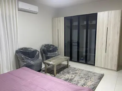 a bedroom with a bed and two trash cans at apartement khaled in Madaba