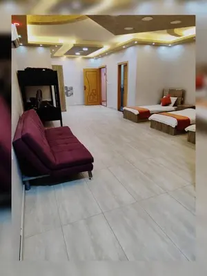a large room with two beds and a couch at The Amazing View chalet in Al Rama
