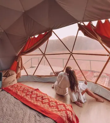 two people laying on the floor in a tent at The Heritage Inn in Disah