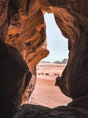 a view of the desert through a rock cave at Desert Glow Wadi Rum in Wadi Rum