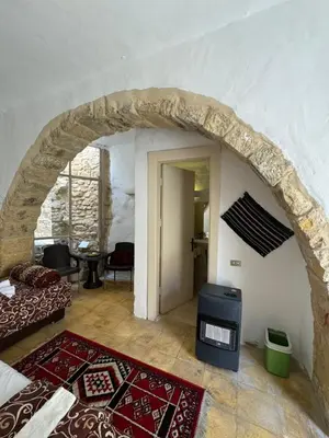 a room with a stone archway and a living room at Night in Dana in Dana