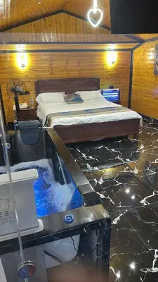 a bedroom with a bed in a room with a tub at Akwakh Al-Kanz Huts Ajloun Jor in Ajloun