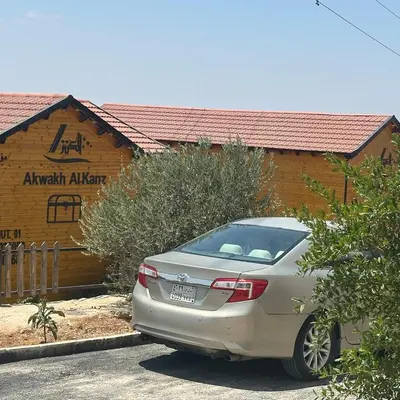 a silver car parked in front of a building at Akwakh Al-Kanz Huts Ajloun Jor in Ajloun