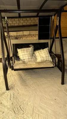 a bed in the sand with two white pillows at Akwakh Al-Kanz Huts Ajloun Jor in Ajloun