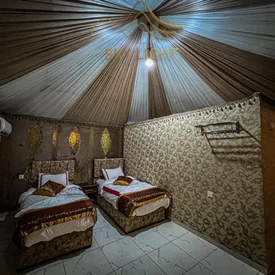 a bedroom with two beds in a tent at Skylight Wadi Rum Camp in Disah