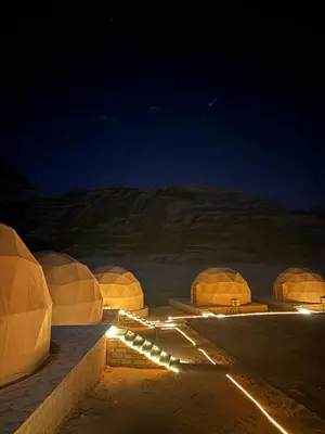 a group of domes in the desert at night at Skylight Wadi Rum Camp in Disah