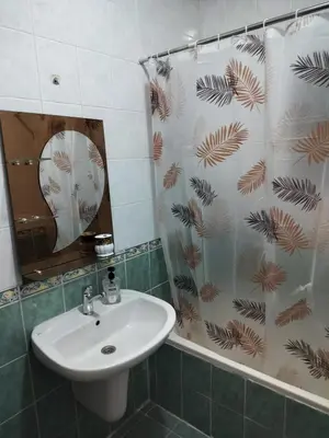 a bathroom with a sink and a shower curtain at Cozy 3 bed-2 bath furnished apartment in Amman