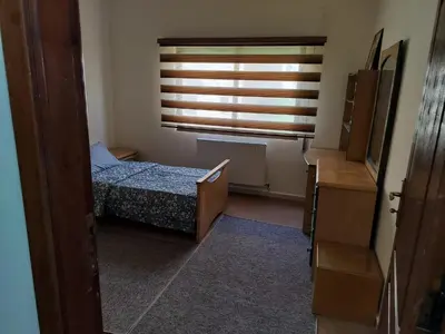 a small bedroom with a bed and a window at Cozy 3 bed-2 bath furnished apartment in Amman