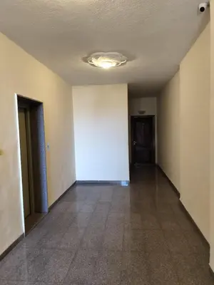 an empty room with a white wall and a hallway at Cozy 3 bed-2 bath furnished apartment in Amman
