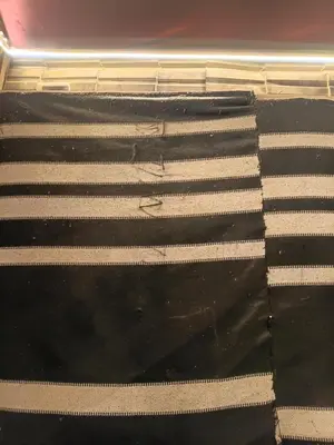 a black and white mattress with white stripes on it at Rum Towers Luxury Camp in Aqaba