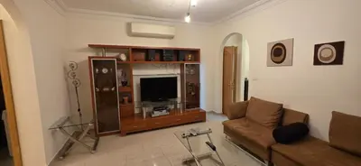 a living room with a couch and a flat screen tv at شقة مفروشة فاخرة in Amman