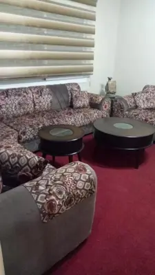 a living room with a couch and two tables at Petra Eyes in Wadi Musa