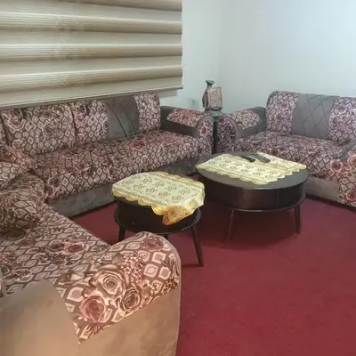 a living room with two couches and two tables at Petra Eyes in Wadi Musa